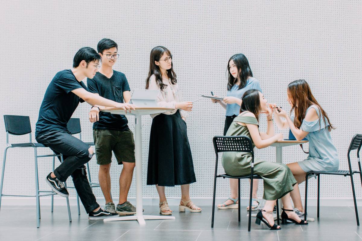 A group of people sitting around each other.