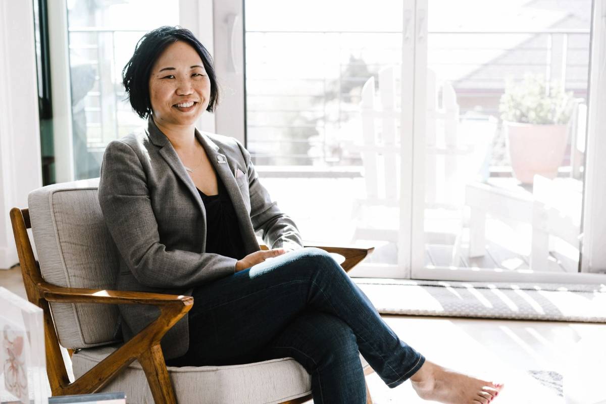 A woman sitting in a chair with her feet up.