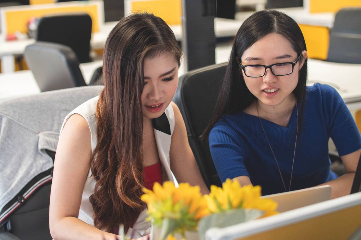 Two women looking at a laptop screen