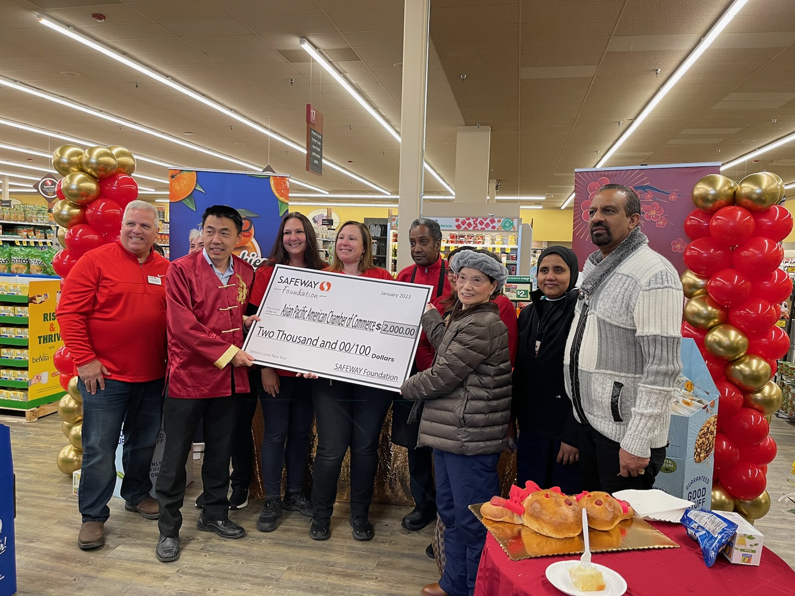 A group of people holding up a large cheque.