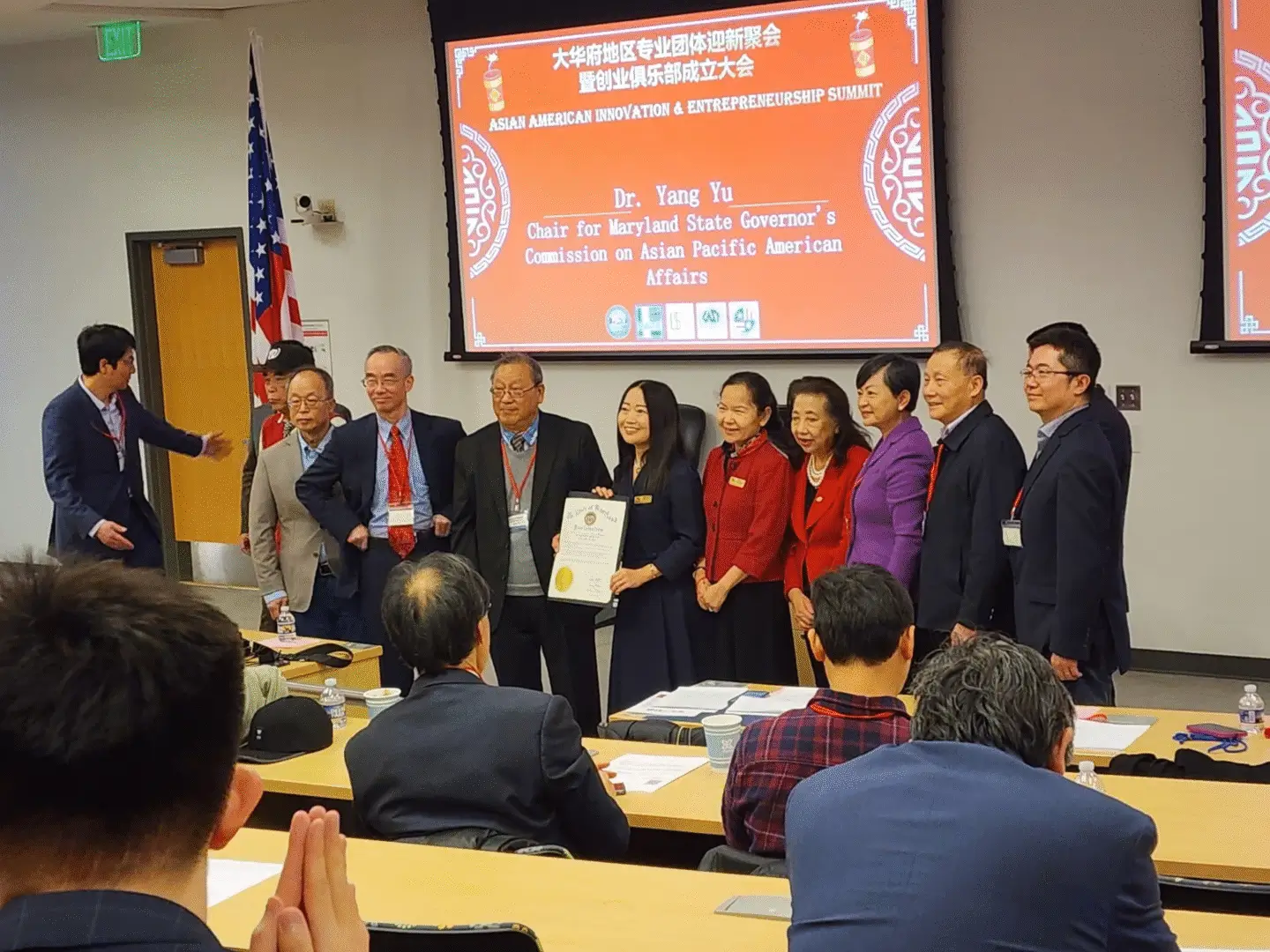 Group posing with certificate at conference