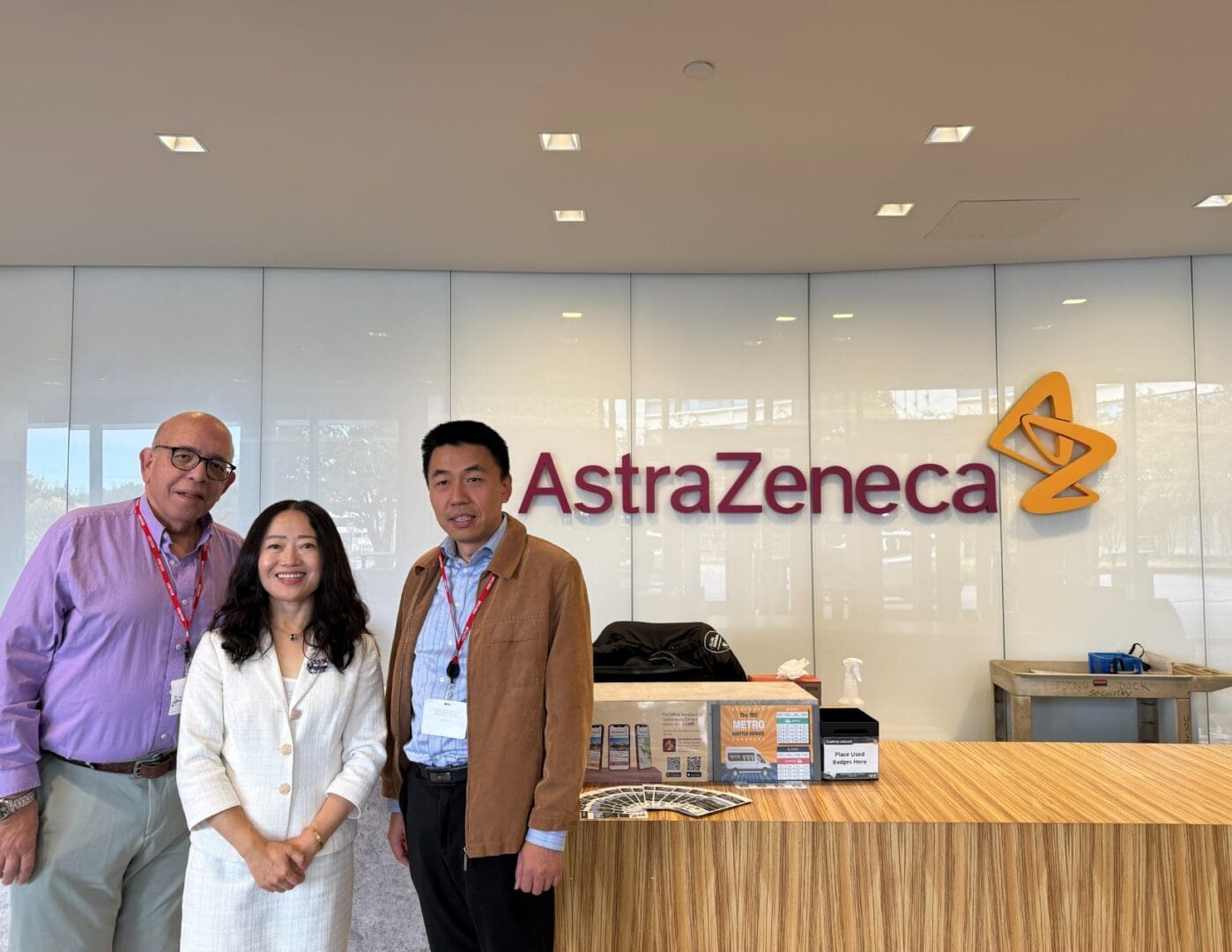 Three people at AstraZeneca reception desk