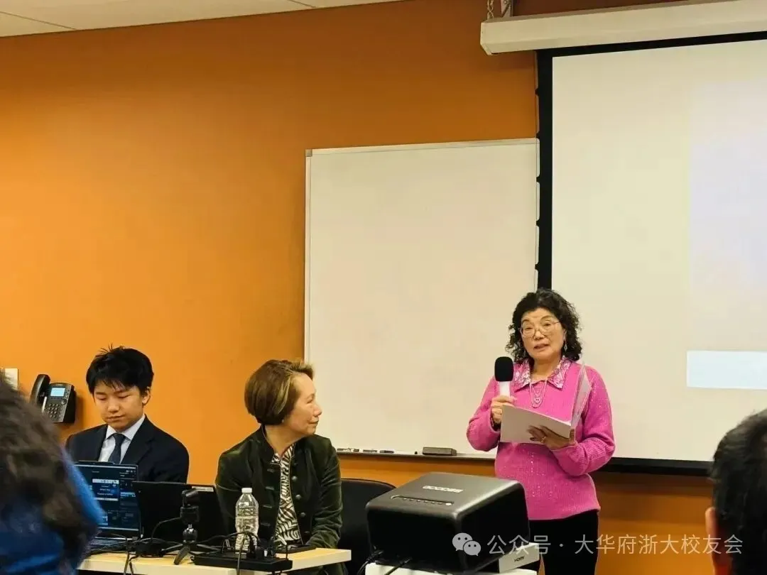 Woman speaking into microphone at panel discussion