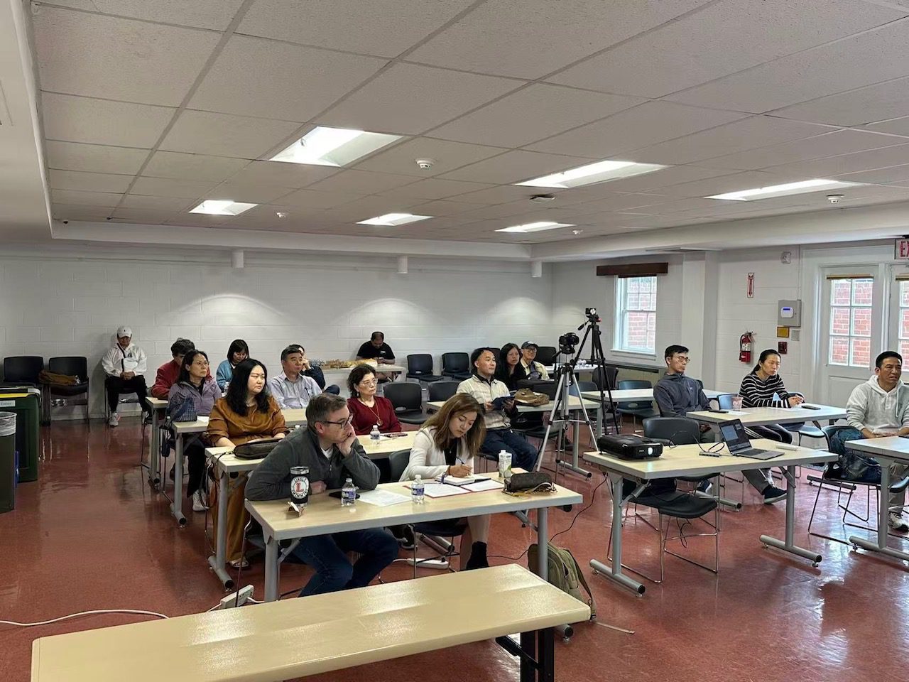 Adults seated in classroom listening to lecture